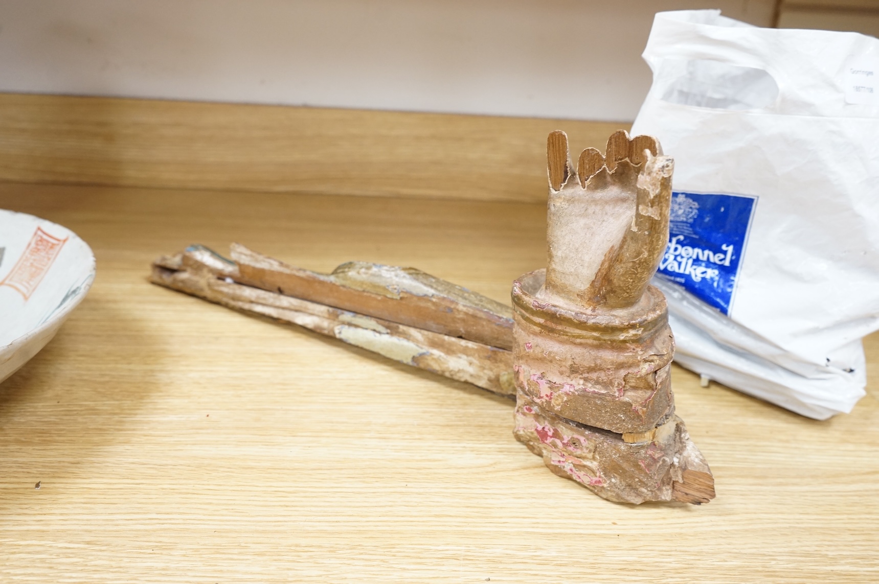 An 18th/19th century painted wood model of a Saint's arm, 56cm